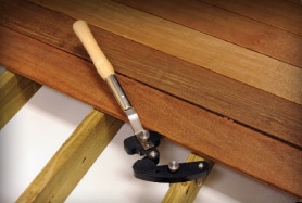 Plan to use a sturdy deck board straightening tool, such as the Hardwood Wrench or BoWrench when installing hardwood decking. Courtesy of IpeClip Fastener Co.