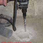 Drilling concrete to install radon mitigation system.