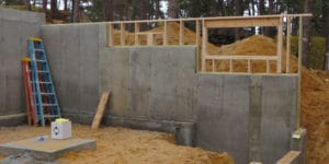 Stepped footing for walk-out foundation