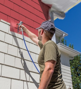 Airless paint sprayer applies exterior paint and solid stain