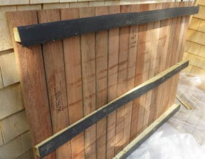 Rooftop wood decking is attached to sleepers with attached strips of EPDM to protect the rubber roof membrane. Decking panels are removable.
