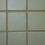 This Old Grout grout sealer restored this badly stained grout on a ceramic tile floor.