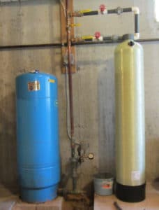 THe acid neutralizing tank passes the water through calcium carbonate to reduce the well water's acidity.