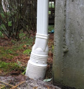 Downspout adapted connects downspout to burried 4-in PVC drain line.