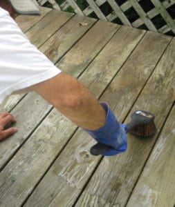 Use stiff brush to scrub cleaner on deck trouble spots.