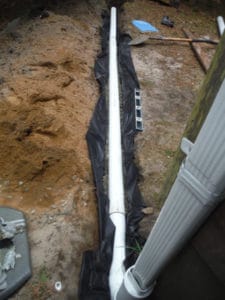 On flat sites, water from down spouts can drain to a dry well.