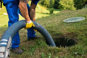 Septic system maintenance includes pumping sludge and scum from septic tank.