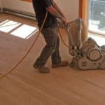 Sanding and refinishing restores hardwood flooring to its original condition.