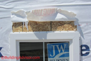 Poor installation of Tyvek creates leak at window head flashing.