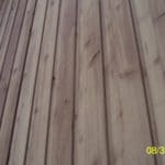 Knots in flat-sawn cedar siding can loosen from excess moisture