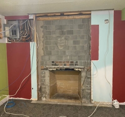 The foil-faced insulation behind this fireplace provides an air